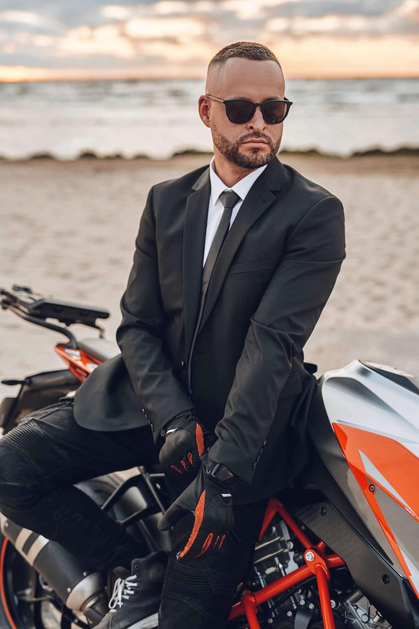 cool-guy-with-sunglasses-and-dark-motorcycle-on-beach.jpg